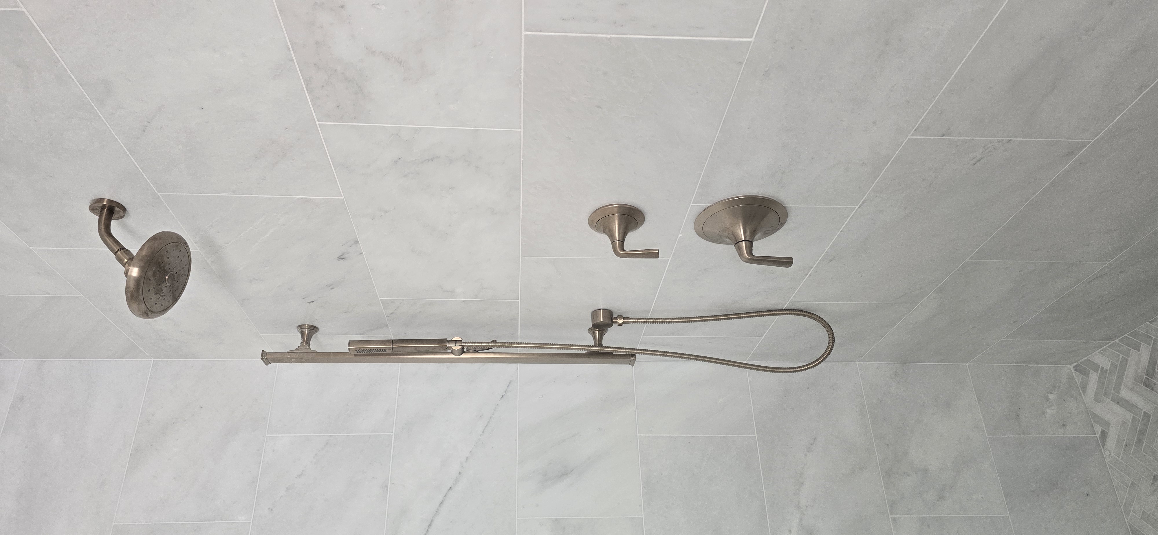Shower system on marble tile with hand shower