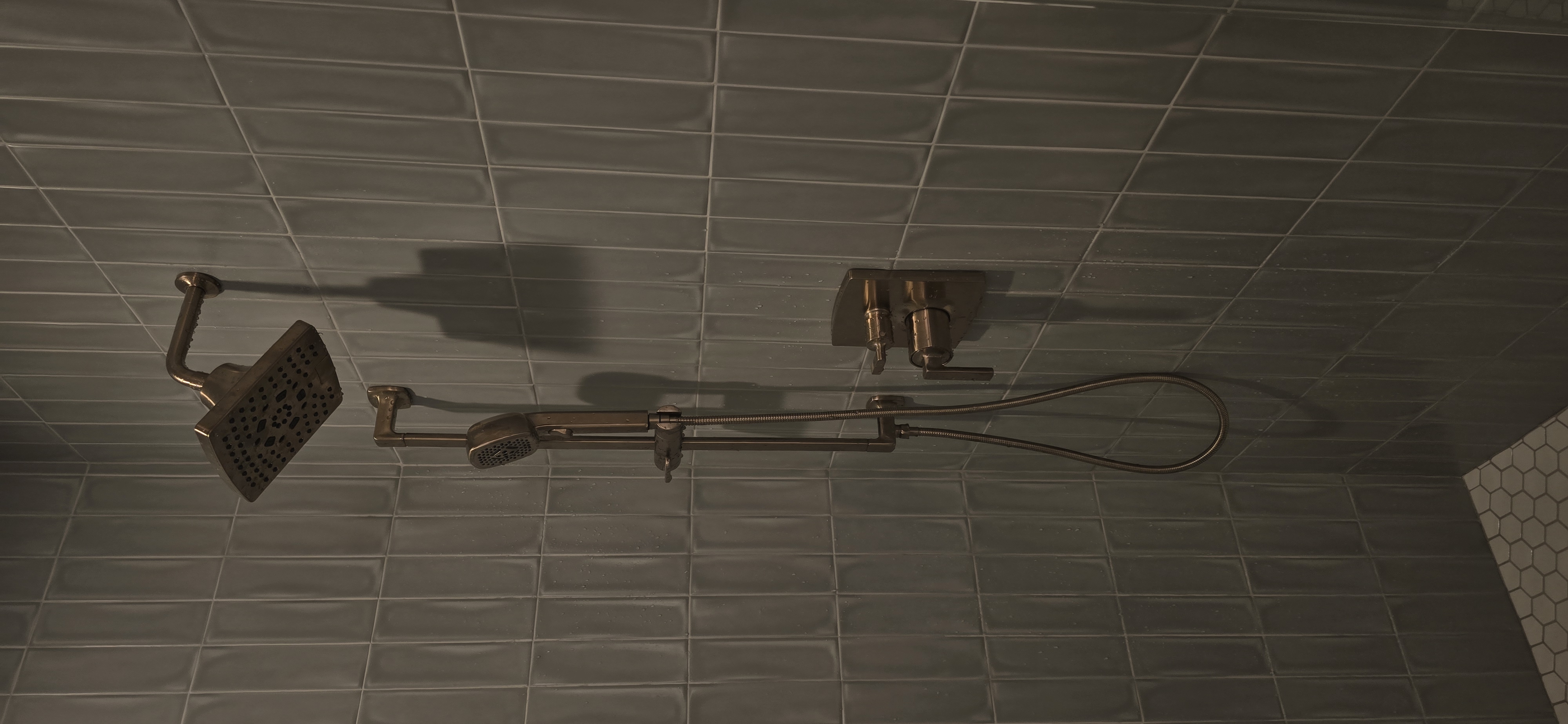 Shower system with rain head on grey tile