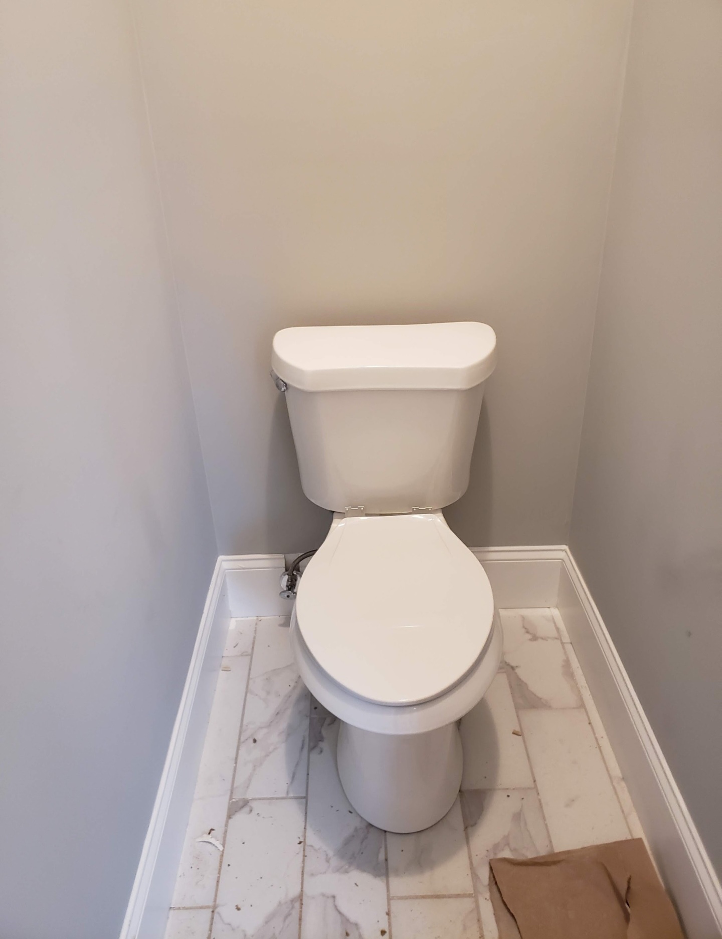 Toilet installation with marble tile floor