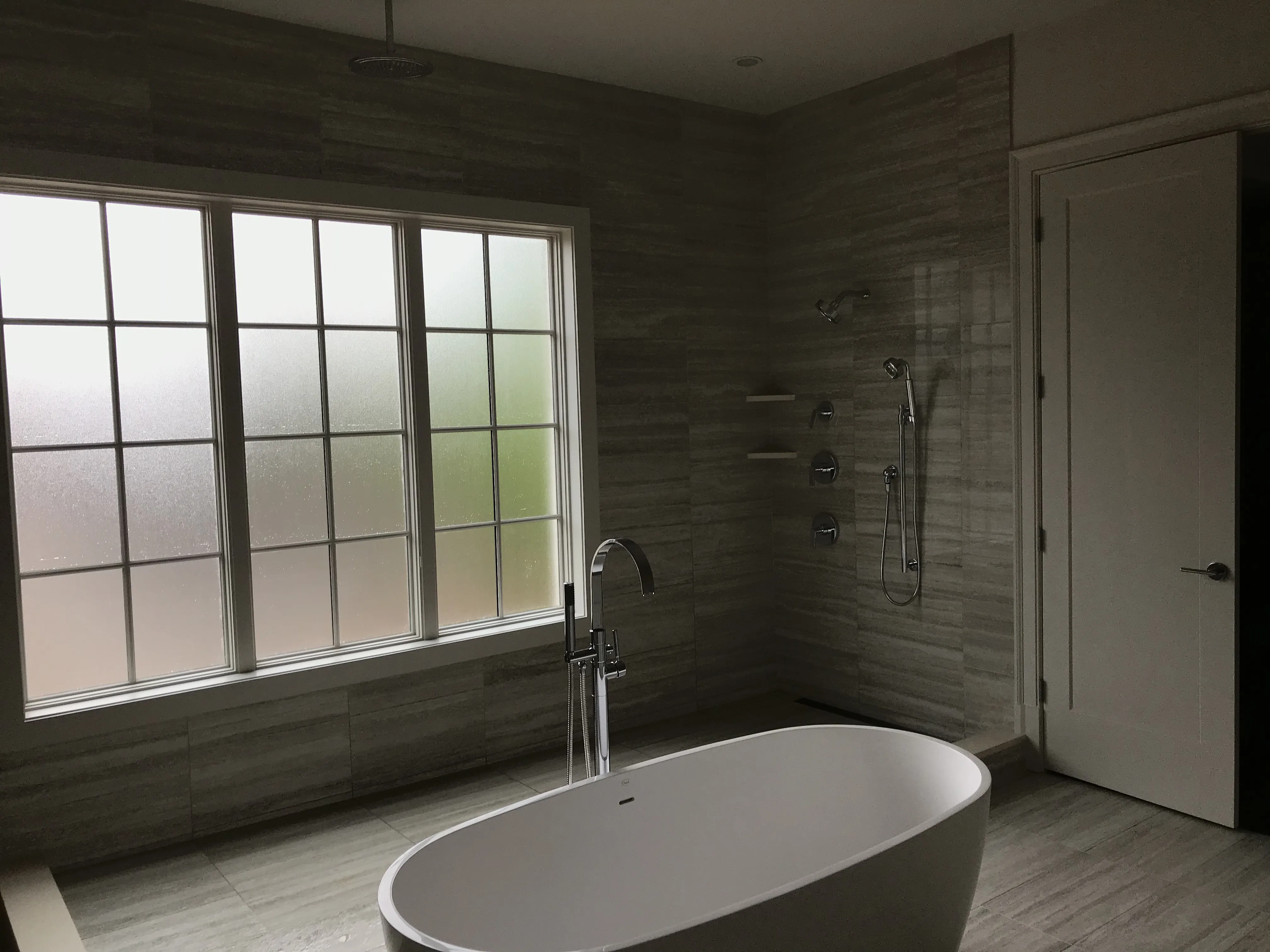 Luxury bathroom with freestanding tub and rain shower